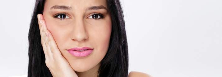 A woman resting her hand against her cheek