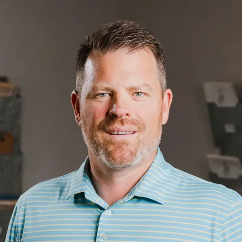 Chiropractor Jeff Morrey in a blue stripped polo shirt.